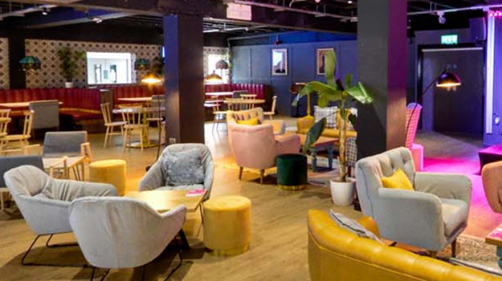 Informal bar area with seating and tables